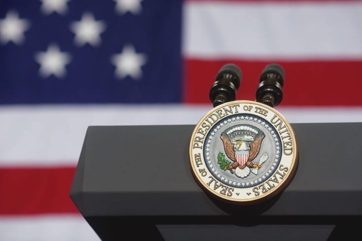 Presidential seal on a podium.