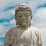 buddha statue against bright blue sky