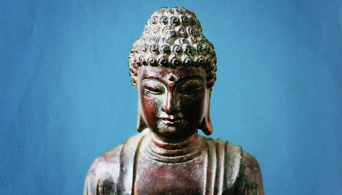 Buddha statue on blue background.