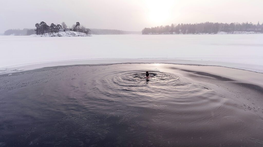 woman swims in a frozen lake