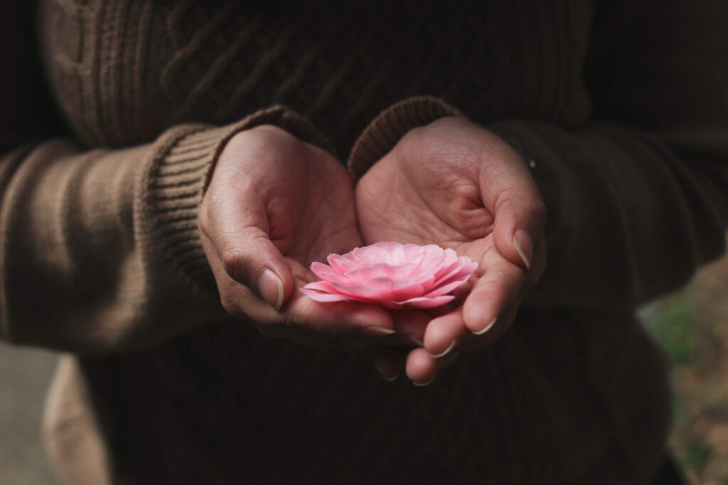 Holding a flower.