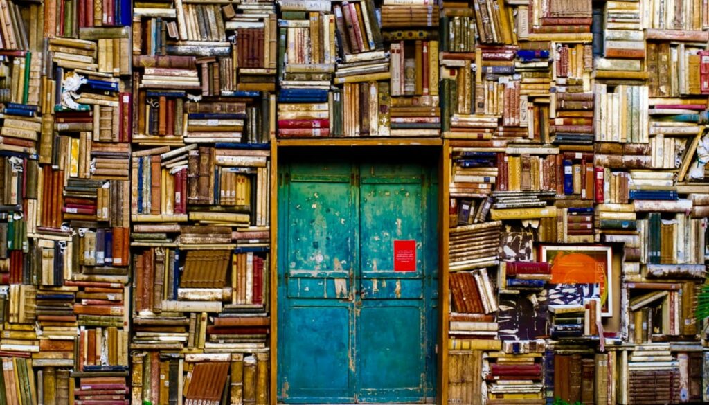 Wall of books with door.