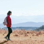 Woman walking through mountain trails.