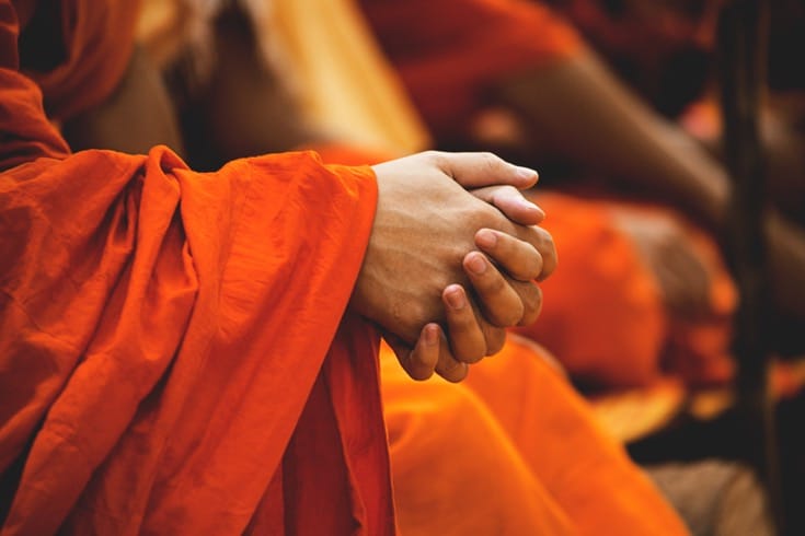 Thai monk with hands folded.