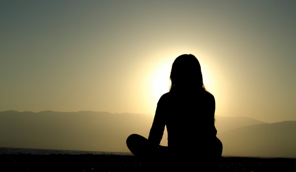 A person meditating in the sun.