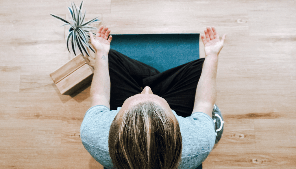 Photo taken from above of woman meditating